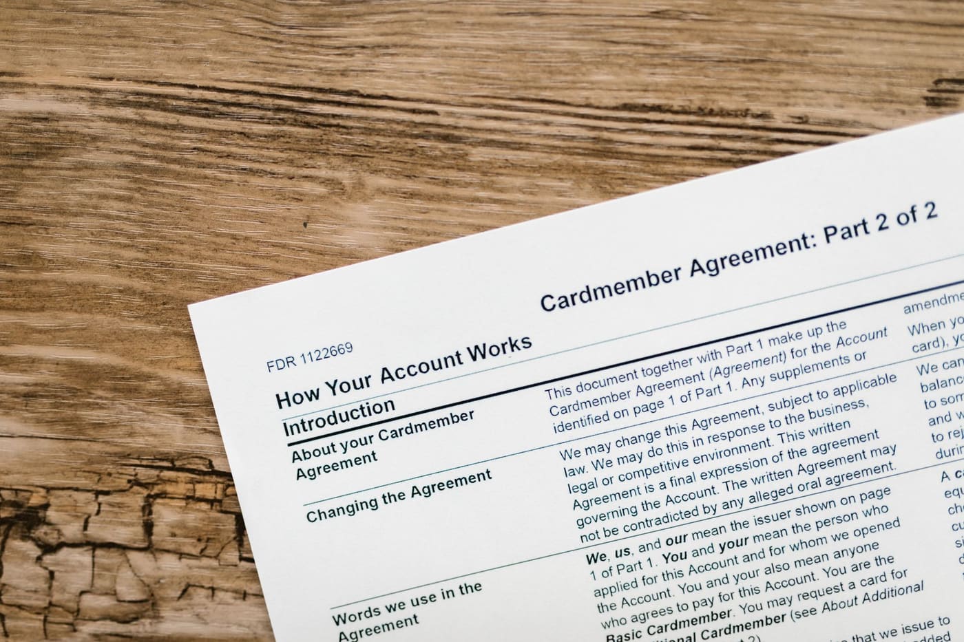 A credit card agreement document on a wooden desk